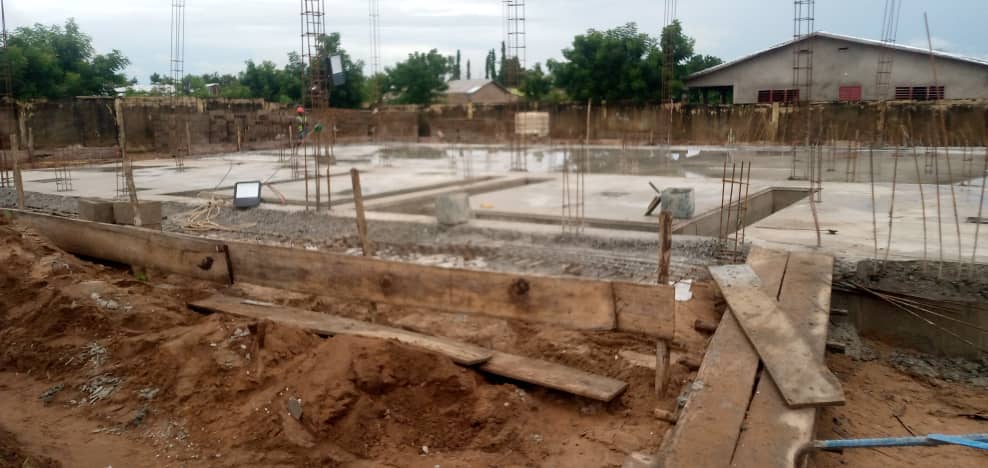 Construction work on the Glazoué substation building — interior drainage channels
